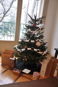 Tree with a snowy backyard in the background